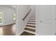 Staircase features hardwood treads, white risers, and a stained wood handrail at 2122 Pembroke Dr, Brookhaven, GA 30319
