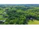 An aerial view shows the landscape has both wooded areas and lush pasture land at 4250 Deerfield Rd, Cumming, GA 30028