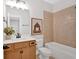 Well-lit bathroom with tub, neutral tile, and vanity with modern fixtures at 4720 Cooling Water Sw Cir, Powder Springs, GA 30127