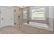 Bright bathroom with a glass enclosed shower and a large soaking tub at 4720 Cooling Water Sw Cir, Powder Springs, GA 30127