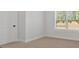 Carpeted bedroom with natural light coming from a large window at 4720 Cooling Water Sw Cir, Powder Springs, GA 30127