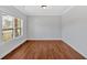 Spacious bedroom features a large window offering great light and hardwood floors throughout at 4720 Cooling Water Sw Cir, Powder Springs, GA 30127
