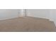 Large, carpeted bedroom with light-colored walls and a doorway leading to another room at 4720 Cooling Water Sw Cir, Powder Springs, GA 30127