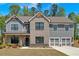 Charming two-story home features a combination of brick and gray siding, complemented by a well-manicured front lawn at 4720 Cooling Water Sw Cir, Powder Springs, GA 30127