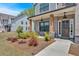 Inviting front porch with brick pillars, a stone foundation, and dark wood door welcomes you to this beautiful home at 4720 Cooling Water Sw Cir, Powder Springs, GA 30127