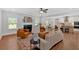 Spacious living room with a fireplace, hardwood floors, and large windows offering plenty of natural light at 4720 Cooling Water Sw Cir, Powder Springs, GA 30127