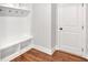 Mud room with built-in storage, hooks, and bench; hardwood floors at 4720 Cooling Water Sw Cir, Powder Springs, GA 30127