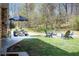 Relaxing backyard with patio, fire pit, and Adirondack chairs, perfect for outdoor entertaining at 5925 Old Bill Cook Rd, South Fulton, GA 30349