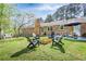 Spacious backyard featuring a patio, fire pit, and swing, ideal for outdoor enjoyment and gatherings at 5925 Old Bill Cook Rd, South Fulton, GA 30349