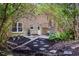 View of a backyard featuring stepping stones, a small patio, and nice landscaping at 5925 Old Bill Cook Rd, South Fulton, GA 30349