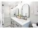 Stylish bathroom featuring double vanity with elegant dark hardware, mirrors, and glass shower at 5925 Old Bill Cook Rd, South Fulton, GA 30349