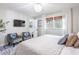 Well-lit bedroom featuring a decorative crystal chandelier, seating and large windows at 5925 Old Bill Cook Rd, South Fulton, GA 30349
