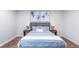 Inviting bedroom with a plush blue bed, matching side tables, and elegant artwork creating a serene atmosphere at 5925 Old Bill Cook Rd, South Fulton, GA 30349