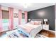 Cozy bedroom features stylish decor, a dark accent wall, and bright natural light at 5925 Old Bill Cook Rd, South Fulton, GA 30349