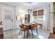 Dining room with tiled floors, modern light fixture, wood blinds, and access to backyard at 5925 Old Bill Cook Rd, South Fulton, GA 30349