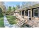 Beautiful brick home with inviting porch, well-manicured lawn, and colorful flower beds at 5925 Old Bill Cook Rd, South Fulton, GA 30349