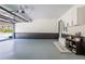 Clean and organized garage with gray floor, storage cabinets, and natural light at 5925 Old Bill Cook Rd, South Fulton, GA 30349