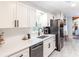 Modern kitchen featuring white cabinets, stainless steel appliances, black hardware, and tiled flooring at 5925 Old Bill Cook Rd, South Fulton, GA 30349