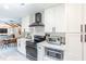 Bright kitchen featuring white cabinets, quartz countertops, and modern stainless steel appliances at 5925 Old Bill Cook Rd, South Fulton, GA 30349