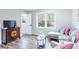 Comfortable living room with a window, stylish decor, and wood flooring at 5925 Old Bill Cook Rd, South Fulton, GA 30349