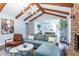 Living room featuring a blue couch, brick fireplace, wooden beams, and an open-concept layout at 5925 Old Bill Cook Rd, South Fulton, GA 30349