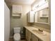Bright bathroom features white cabinetry and vanity with neutral countertop at 633 Iris Rd, Pine Lake, GA 30072