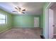 Spacious bedroom with neutral carpet, ceiling fan, and natural light at 633 Iris Rd, Pine Lake, GA 30072