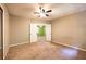 Spacious bedroom with neutral walls and carpet with view to second bedroom at 633 Iris Rd, Pine Lake, GA 30072