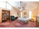 Comfortable bedroom with a ceiling fan, bookshelf, lots of light, and a cozy reading chair at 633 Iris Rd, Pine Lake, GA 30072