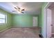 Spacious bedroom with neutral walls, carpet floors and ceiling fan at 633 Iris Rd, Pine Lake, GA 30072