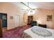 Comfortable bedroom featuring a bookcase, ceiling fan, and access to an ensuite bathroom at 633 Iris Rd, Pine Lake, GA 30072