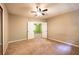Spacious carpeted bedroom with a ceiling fan and a door that leads to another room at 633 Iris Rd, Pine Lake, GA 30072