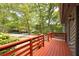 Close up of the red deck on the front of the house, with wood railings at 633 Iris Rd, Pine Lake, GA 30072