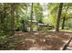 Exterior view of the home showcasing its unique architecture nestled among mature trees at 633 Iris Rd, Pine Lake, GA 30072