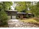 Inviting gray home featuring a two-car garage and a welcoming red deck entrance at 633 Iris Rd, Pine Lake, GA 30072