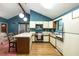 View of kitchen with stainless appliances, island seating, and hardwood floors at 633 Iris Rd, Pine Lake, GA 30072