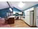 Kitchen featuring white cabinetry, laminate countertop and breakfast bar at 633 Iris Rd, Pine Lake, GA 30072