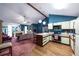 Living area featuring a fireplace, wood floors, vaulted ceiling, and open kitchen at 633 Iris Rd, Pine Lake, GA 30072
