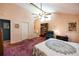 Cozy main bedroom with vaulted ceiling, book case, adjacent bathroom and comfortable chair at 633 Iris Rd, Pine Lake, GA 30072