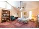 Spacious main bedroom featuring a vaulted ceiling, bookcase and fan with a light fixture at 633 Iris Rd, Pine Lake, GA 30072