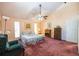 Large main bedroom has vaulted ceiling, fan and window with a view at 633 Iris Rd, Pine Lake, GA 30072