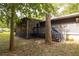 Back of the house with a screened porch and deck with steps leading down at 633 Iris Rd, Pine Lake, GA 30072
