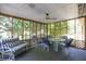 Enclosed porch with furniture and peaceful backyard view at 633 Iris Rd, Pine Lake, GA 30072