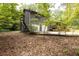 Exterior side with staircase to the upper level and a two car garage at 633 Iris Rd, Pine Lake, GA 30072