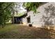 Exterior side view of the home with a screened porch and wood siding at 633 Iris Rd, Pine Lake, GA 30072