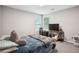 Cozy bedroom with a large window and a bed with a blue comforter and decorative pillows at 9744 Musket Ridge Cir, Jonesboro, GA 30238