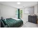 Neutral bedroom featuring a bed, large window, and decor against the wall at 9744 Musket Ridge Cir, Jonesboro, GA 30238