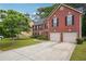 Charming two-story brick home with a two-car garage and a well-maintained front yard at 9744 Musket Ridge Cir, Jonesboro, GA 30238