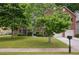 Traditional brick home with a lush green lawn, mature trees, and a two-car garage at 9744 Musket Ridge Cir, Jonesboro, GA 30238