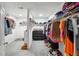Spacious walk-in closet with ample storage and shelving, filled with clothing and shoes at 9744 Musket Ridge Cir, Jonesboro, GA 30238